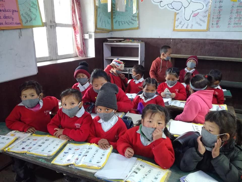 Children wearing masks in a school in Lukla