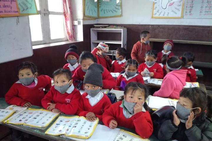 Children wearing masks in a school in Lukla